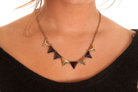 A close up of a necklace with gold and black triangles.の写真素材