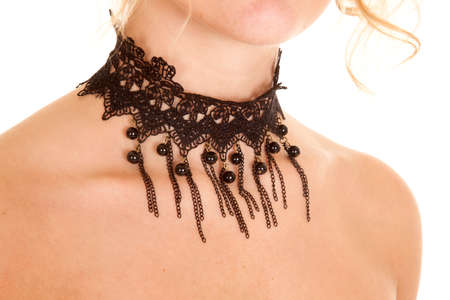 A woman wearing a lace and beaded necklace.の写真素材