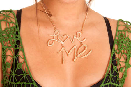 A close up picture of a woman's neck with a necklace that says love me.の写真素材