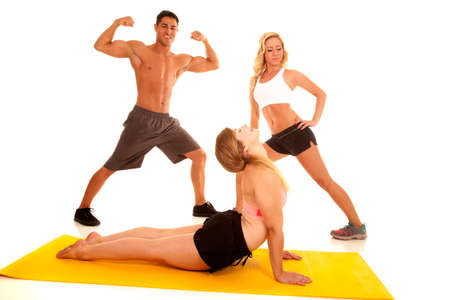 A man with two women stretching out their bodies.の写真素材