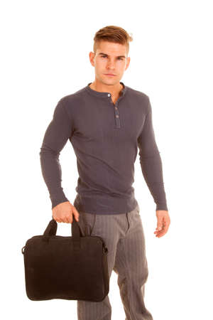 A man in his business clothing holding on to his bag heading to the office.の写真素材
