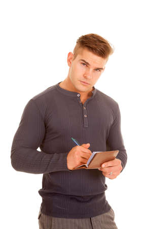 a man with a serious expression on his face, writing out a check.の写真素材