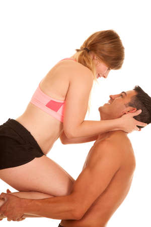 a woman and man in their fitness clothing, the man is holding up the woman smiling at each other.の写真素材