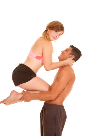 a man holding up his woman on his arms showing how strong he is.の写真素材