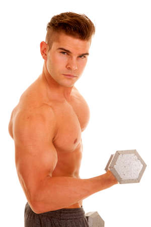 A man with a serious expression on his face lifting up his weights.の写真素材