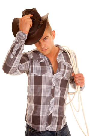 A cowboy in his plaid top and hat with a rope.の写真素材