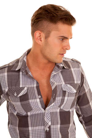 A  man looking to the side in his plaid shirt.の写真素材