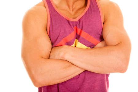 A man with his arms folded in his purple tank.の写真素材