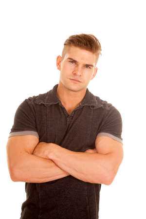a man with a serious expression on his face with his arms folded.の写真素材