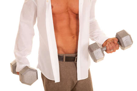 A man working out with weights while still in his business clothes.の写真素材