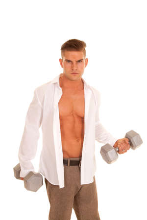 A man in his dress shirt and pants lifting weightsの写真素材