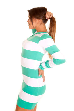 A woman in her mint striped dress holding up her hair.の写真素材