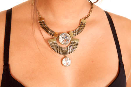 A woman wearing a gold necklace with big rhinestones in the design.の写真素材