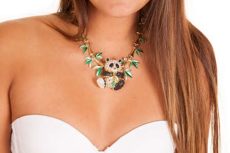 A close up of a woman wearing a panda bear pendant on her necklace.の写真素材