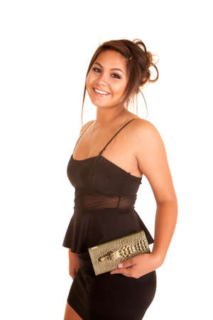 a woman in her short black dress holding on to  a crocodile purse.の写真素材