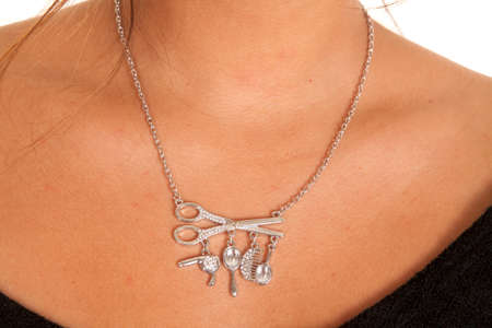 A woman wearing a silver charm necklace.の写真素材