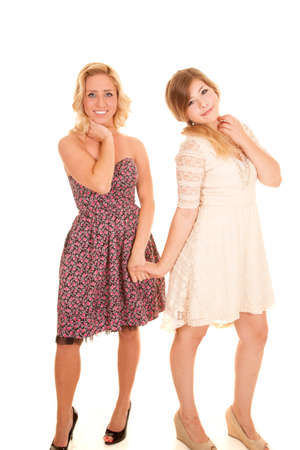 Two woman holding hands with smiles on their faces.の写真素材