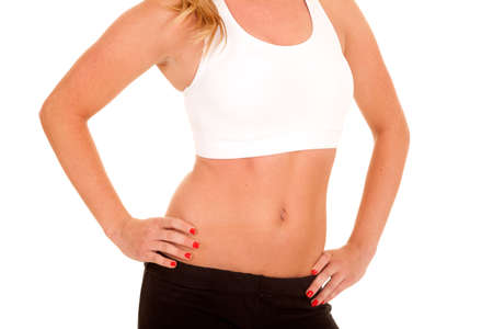 a close up of a woman in her white sports bra, showing her stomach.の写真素材