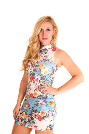 A woman in her fitted flower dress with her hand on her hip.の写真素材