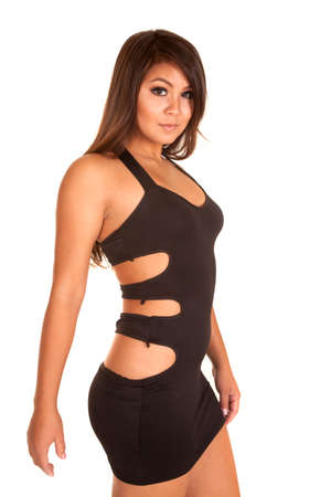 A side view of a woman in her black short dress with holes in the side of her dress.の写真素材