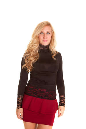 A woman in her business red skirt with a lace black top.の写真素材