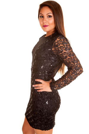a woman showing off the side of her fitted sequin dress, with her hand on her hip,の写真素材