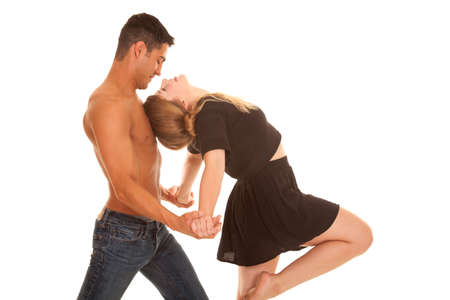 A man leaning his woman into his chest while dancing.の写真素材