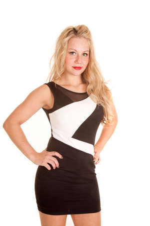 a woman in her black and white design dress with her hands on her hips.の写真素材