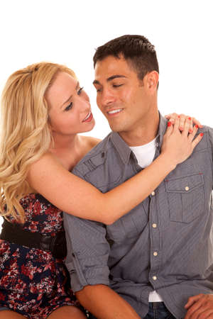 A woman with her arms wrapped around her man looking at him with a smile.の写真素材