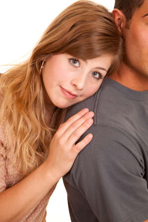 A woman leaning her head on her man's shoulder with a small smile on her lips.の写真素材