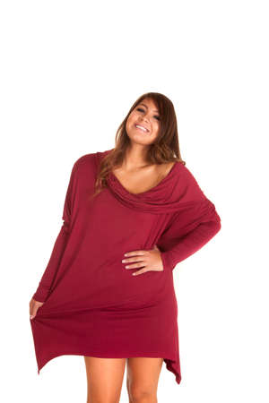 A woman in a big sweater dress playing with the bottom of it.の写真素材