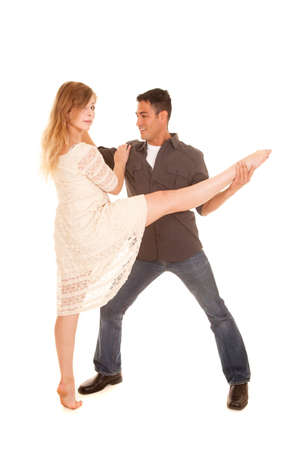 A woman and man dancing, he has her leg held up.の写真素材