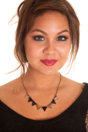 a woman  with a small smile on her face and a necklace on her neck.の写真素材