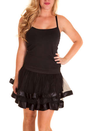 A woman in her black tank and a short ruffle skirt.の写真素材