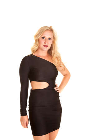 A woman wearing a tight fitting black dress with her shoulder showing.の写真素材