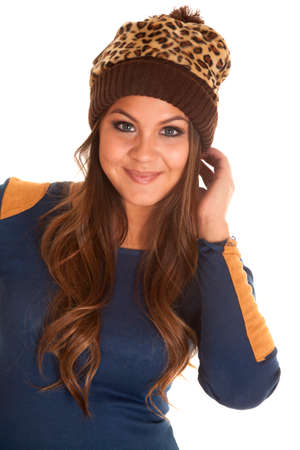 A woman  with a smile on her face, wearing a leopard print beanie.の写真素材