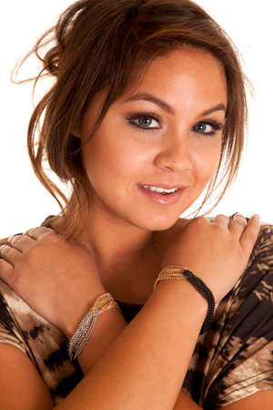 A woman with her arms folded over her shoulders with bracelets.の写真素材