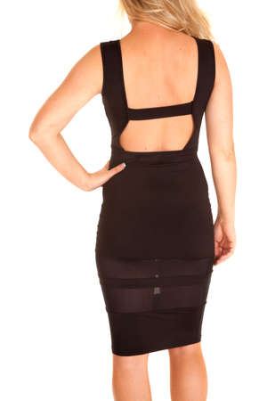 A woman in her short black dress, showing off her back.の写真素材