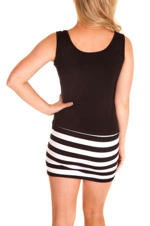 A woman in her black and white stripe dress with her hand on her hip.の写真素材
