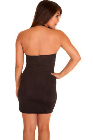 A woman in her short black dress, looking over her shoulder.の写真素材