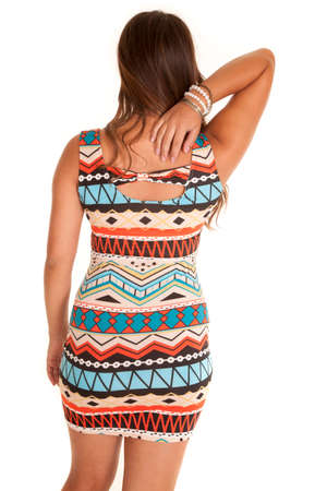 A woman with her back to the camera with a short dress with aztec print.の写真素材