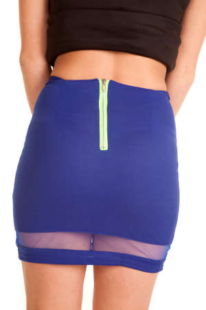 A woman in her black top and blue skirt, showing off the back.の写真素材