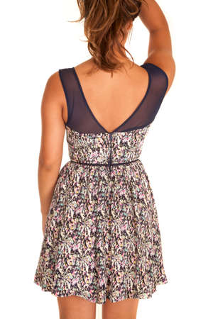 A woman showing off the back of her flower dress.の写真素材