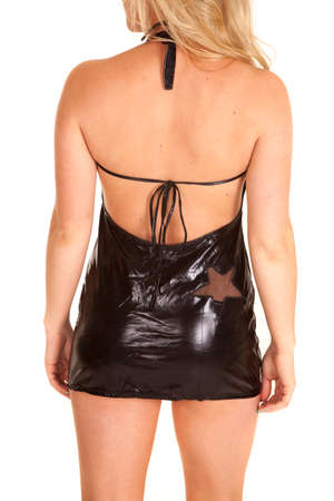 A woman in her black leather dress with a star on her hip.,の写真素材