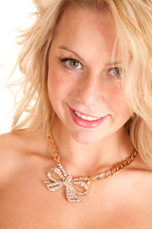 A close up of a woman wearing a necklace with a bow that has rhinestones in it.の写真素材