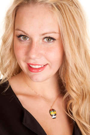 A woman  with a smile, wearing a medicine man skull necklace.の写真素材