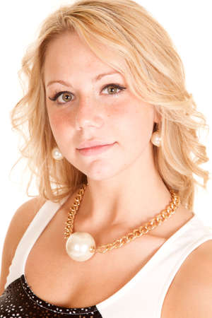 A woman with pearl earrings and a necklace with a pearl on the chain.の写真素材