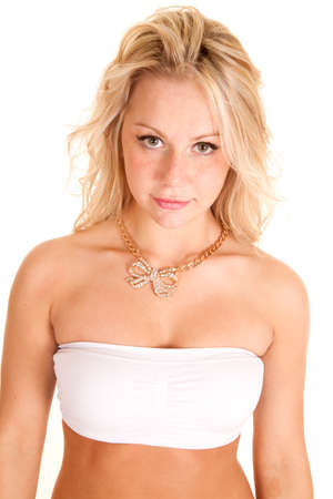 A woman looking wearing a necklace with a bow on the end of it.の写真素材