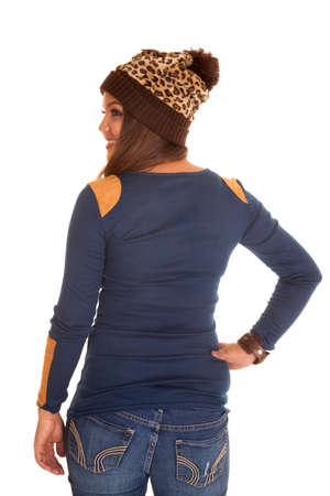 The back of a woman in her sweater and a leopard printed winter hat.の写真素材