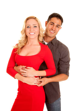A woman in a red dress with her man's arms around her waist.の写真素材